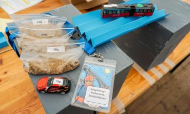 Sandbags, toy cars, and a paper bridge