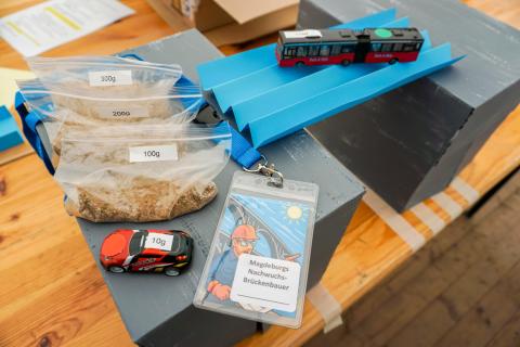Sandbags, toy cars, and a paper bridge
